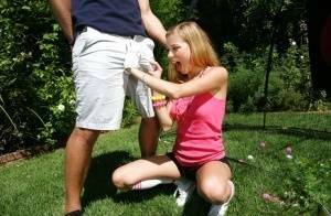 Young blonde girl Nicole Ray giving large dick oral sex outdoors on lawn on fanspics.net