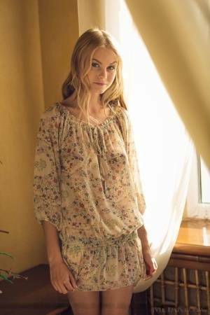 Cute blonde teen Nancy A slips off her floral dress to model naked on fanspics.net