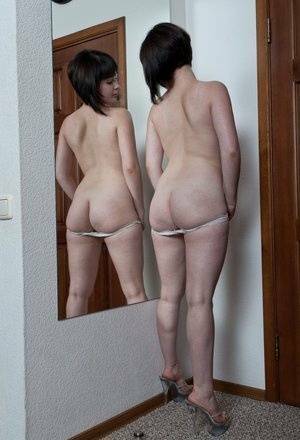 White teen with a full bush admires herself in mirror while disrobing on fanspics.net