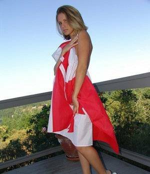 Canadian teen Karen wraps her naked body in a flag on her back deck on fanspics.net