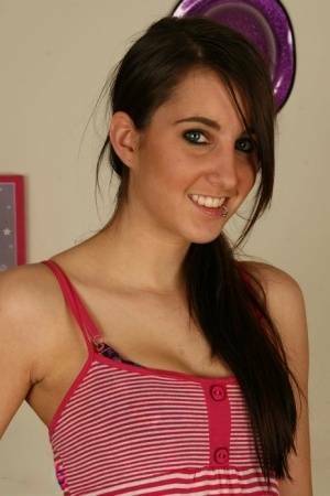 Young brunette Stacy H gets completely naked on a wooden table on fanspics.net