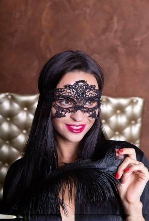 Sexy brunette Leyla Lee removes a mask and robes to pose nude with a feather on fanspics.net