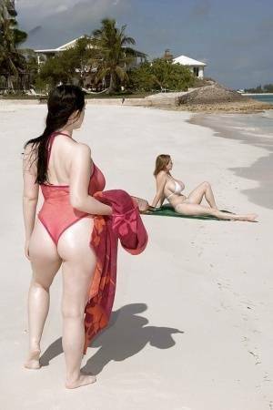 Fervent lesbians stripping nude and playing with dildos on the beach on fanspics.net