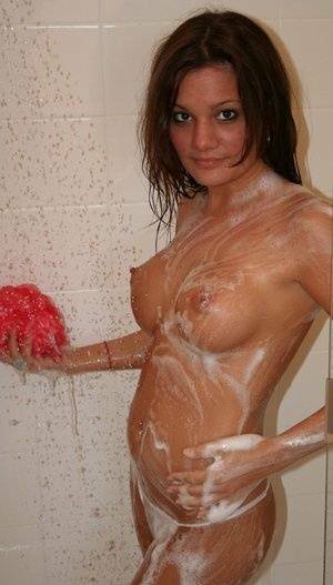 Teen amateur Kate Crush soaps her perky breasts while taking a shower on fanspics.net