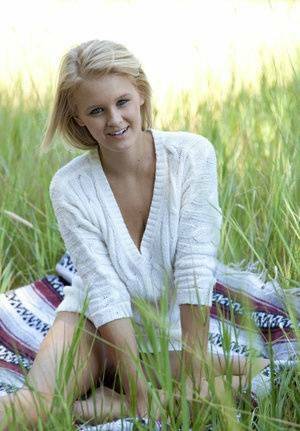 Blue eyed blonde teen Marie casts off her clothes to pose nude in a field on fanspics.net