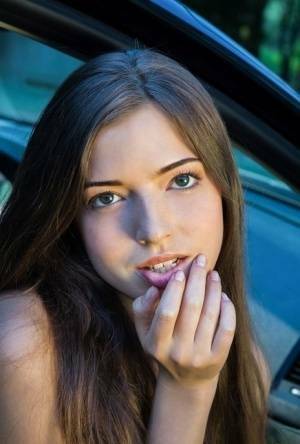 Beautiful teen girl models in the nude on passenger seat of car with door open on fanspics.net