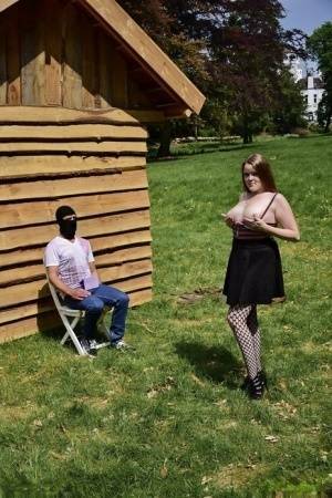 Natural redhead masturbates on a lawn before teasing a masked man on fanspics.net