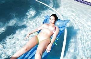 Brunette babe model Ada S going topless on air mattress in swimming pool on fanspics.net