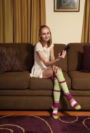 Adorable teen Alicia Williams takes a selfie before getting naked in OTK socks on fanspics.net