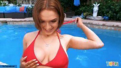 Gracie Gates coyly undoes her top in the pool on fanspics.net